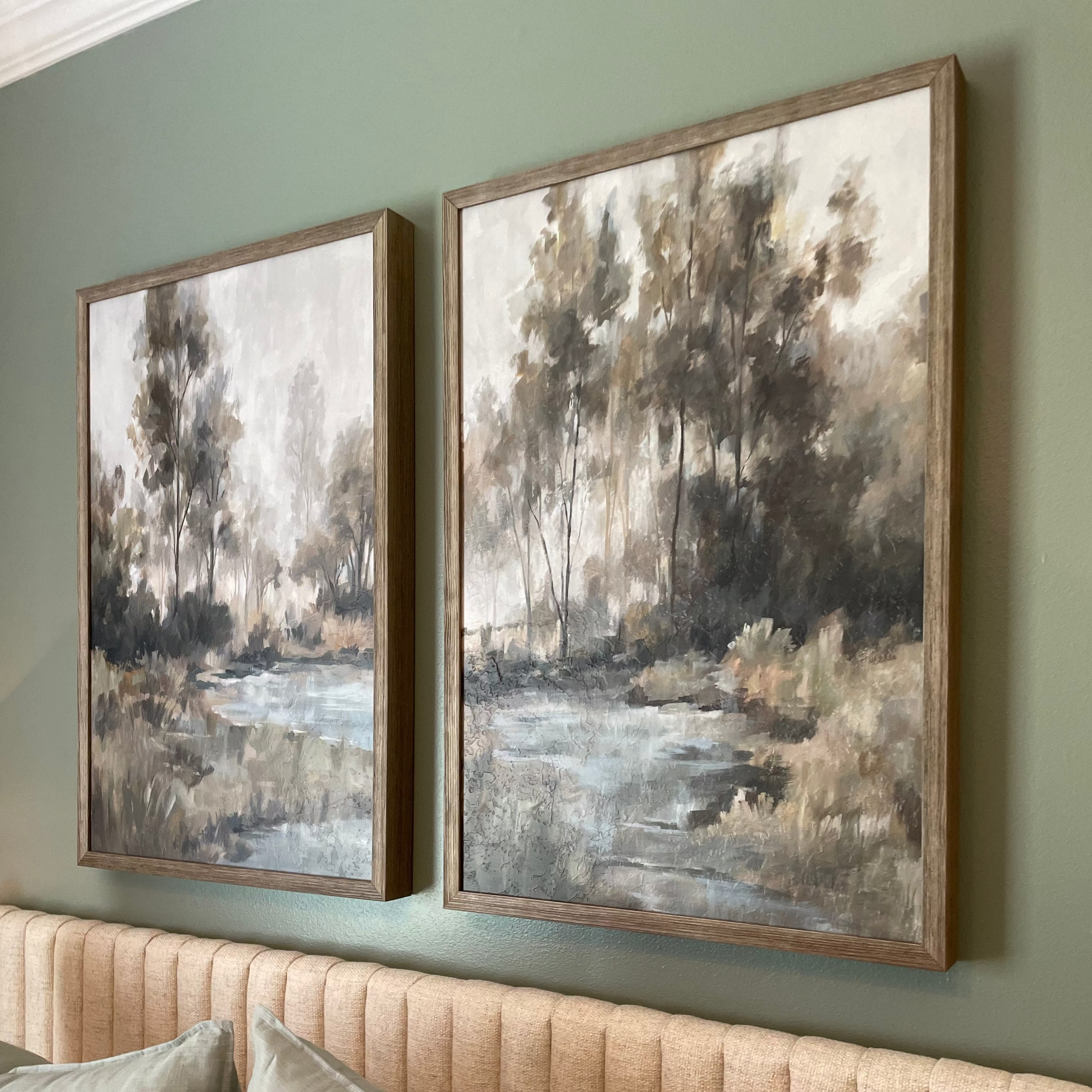 art and mirror over black console table with lamp and modern chandelier 